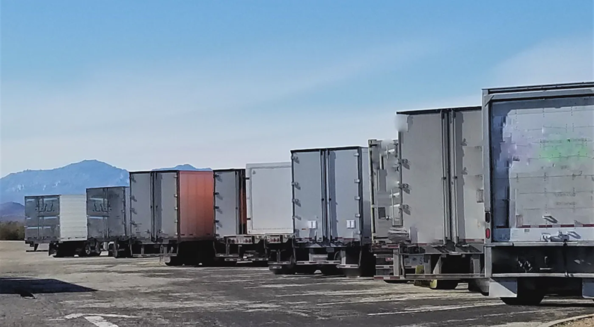 Row of semi trailers parked at a yard
